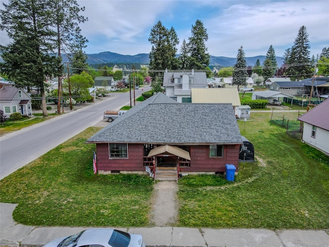 1005 Idaho Ave, Libby, MT 59923 - view of front of home with a shingled roof, a mountain view, and a residential view
