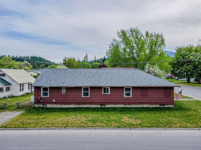 1005 Idaho Ave, Libby, MT 59923 - view of side of property featuring a lawn and a shingled roof