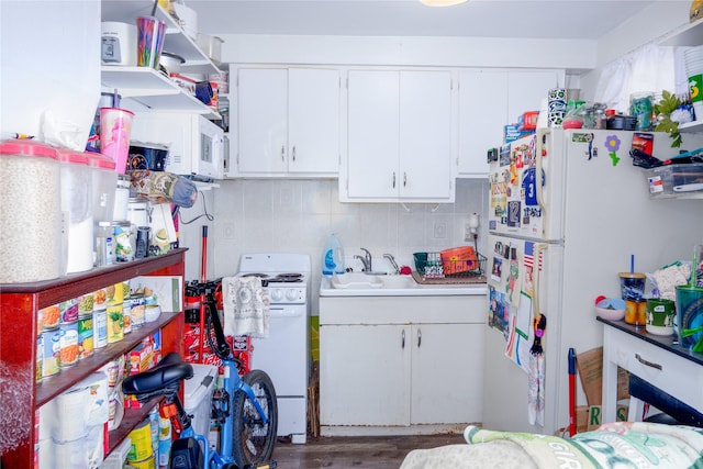 1005 Idaho Ave, Libby, MT 59923 - kitchen with white appliances, white cabinetry, a sink, light countertops, and decorative backsplash