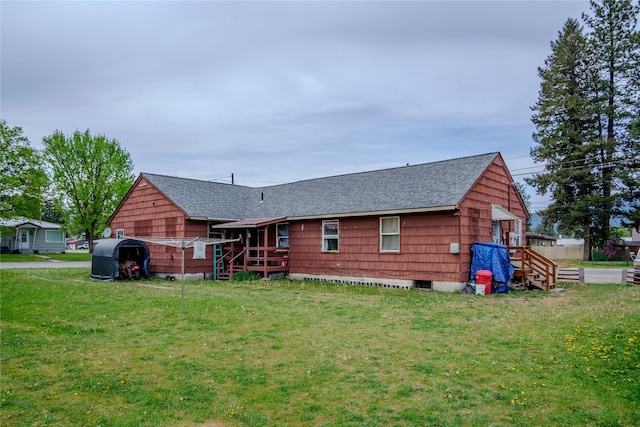 1005 Idaho Ave, Libby, MT 59923 - rear view of house with a shingled roof and a lawn
