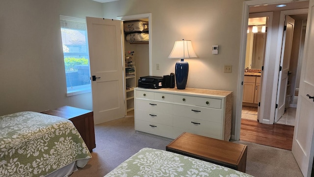 270 Bridge St Unit Qc1-103, Bigfork, MT 59911 - bedroom featuring a spacious closet, carpet flooring, a closet, a desk, and ensuite bath