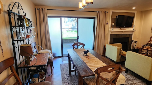270 Bridge St Unit Qc1-103, Bigfork, MT 59911 - dining area with wood finished floors, a fireplace, and recessed lighting