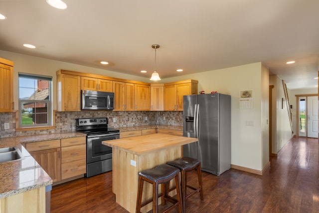 61253 Watson Rd, Saint Ignatius, MT 59865 - kitchen with appliances with stainless steel finishes, butcher block counters, backsplash, dark wood-type flooring, and recessed lighting