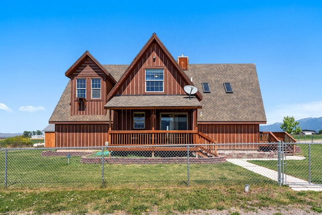 61253 Watson Rd, Saint Ignatius, MT 59865 - view of front of home with a porch, roof with shingles, a mountain view, and a chimney