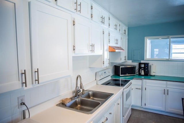 kitchen featuring white electric range oven, stainless steel microwave, a sink, white cabinets, and backsplash