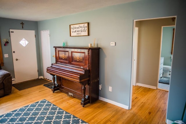 foyer with wood finished floors and baseboards