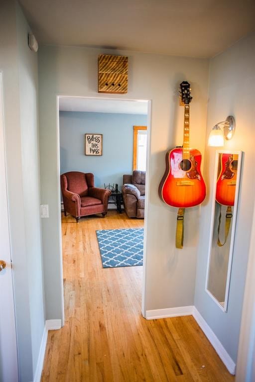 hallway with wood finished floors and baseboards