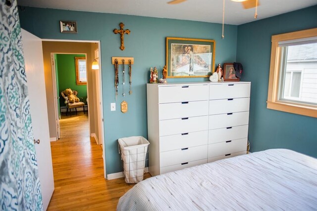 bedroom with wood finished floors and baseboards