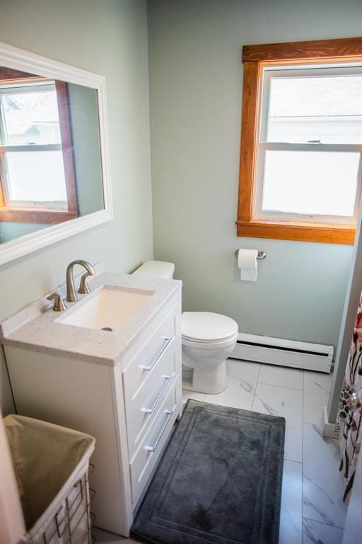 bathroom with a baseboard radiator, marble look tile flooring, vanity, and toilet