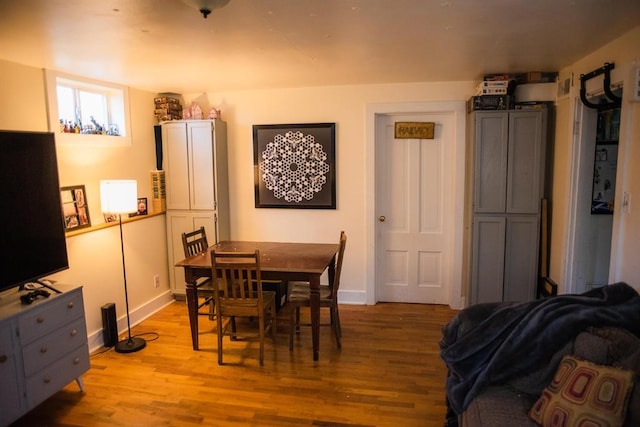 dining area featuring wood finished floors and baseboards