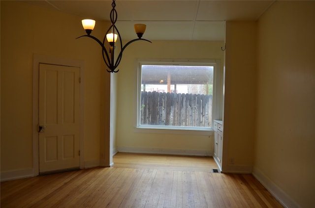 218 W Broadway St, Philipsburg, MT 59858 - unfurnished dining area featuring plenty of natural light, light wood-style flooring, and a chandelier