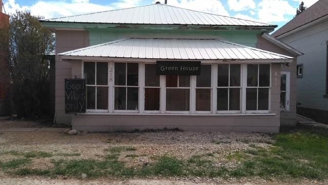 218 W Broadway St, Philipsburg, MT 59858 - view of home's exterior featuring a sunroom and a metal roof