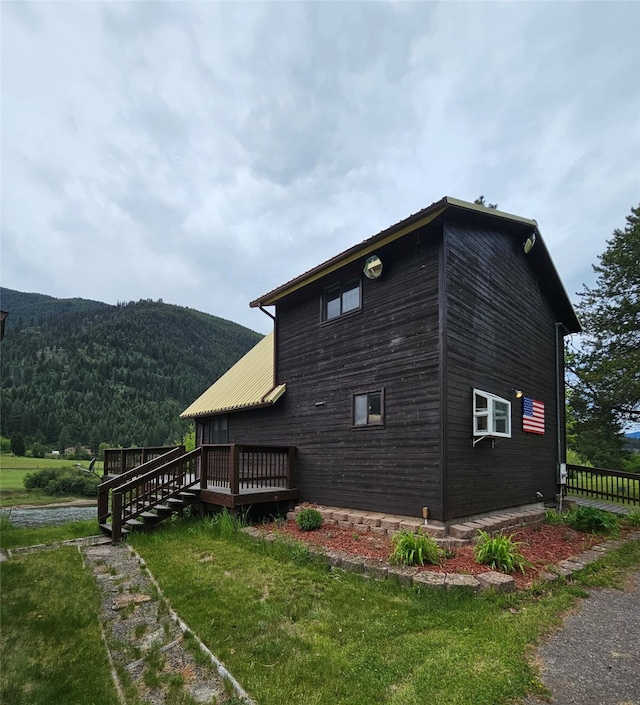 4743 Sloway Frontage Rd, Superior, MT 59872 - view of home's exterior featuring a deck with mountain view and a yard