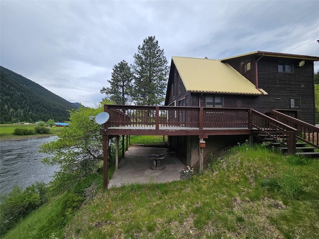 4743 Sloway Frontage Rd, Superior, MT 59872 - back of property featuring a patio, a deck with water view, metal roof, and stairway