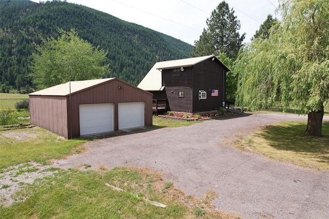4743 Sloway Frontage Rd, Superior, MT 59872 - detached garage featuring a view of trees and a mountain view