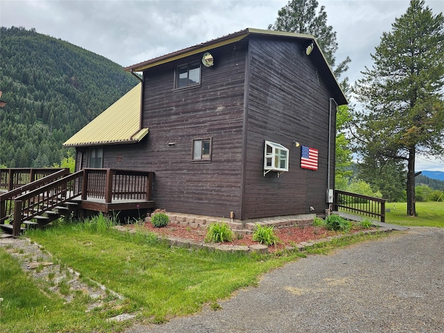 4743 Sloway Frontage Rd, Superior, MT 59872 - view of side of property featuring a deck with mountain view and metal roof