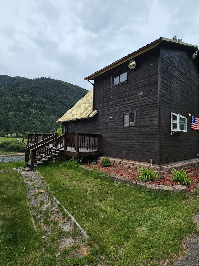 4743 Sloway Frontage Rd, Superior, MT 59872 - view of property exterior with a deck with mountain view and a lawn