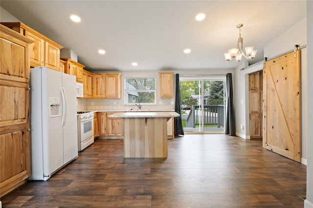 kitchen with white appliances, light brown cabinetry, a barn door, recessed lighting, and a center island