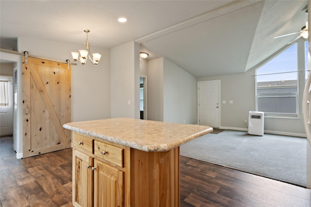 kitchen with dark wood-style flooring, light countertops, a barn door, vaulted ceiling, and a center island