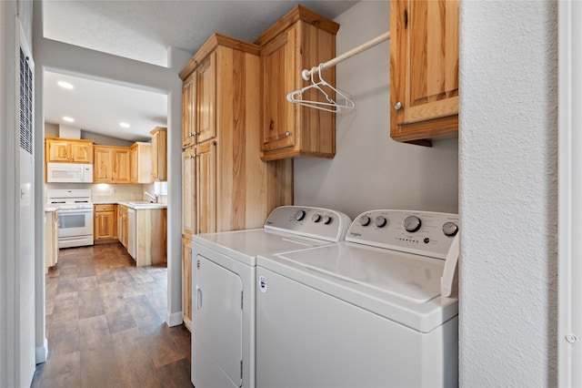 washroom featuring washer and dryer, cabinet space, dark wood-type flooring, and recessed lighting