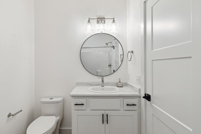 half bath featuring toilet and vanity