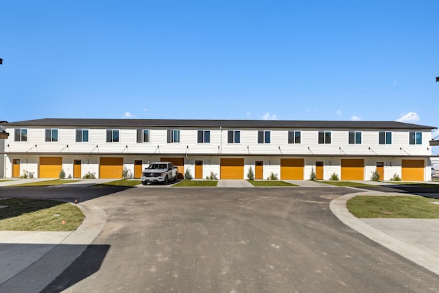 view of building exterior with uncovered parking