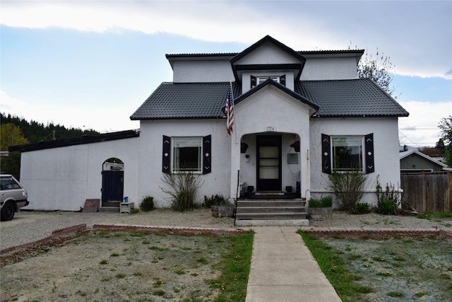 1314 Dakota Ave, Libby, MT 59923 - view of front of property with fence, stucco siding, and a tiled roof