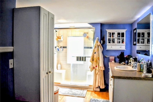 1314 Dakota Ave, Libby, MT 59923 - bathroom featuring wood finished floors, a stall shower, and vanity
