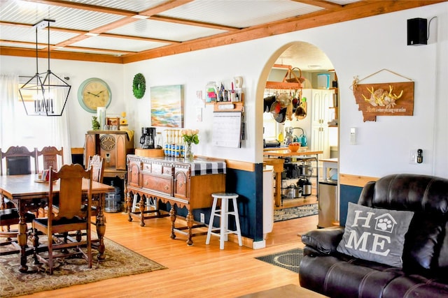1314 Dakota Ave, Libby, MT 59923 - dining space featuring arched walkways, light wood-style flooring, and a chandelier