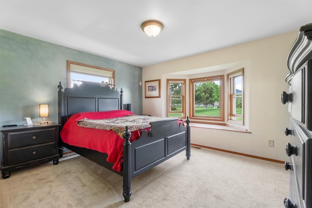 1815 Homestead Dr, Missoula, MT 59808 - bedroom with light carpet, multiple windows, and baseboards