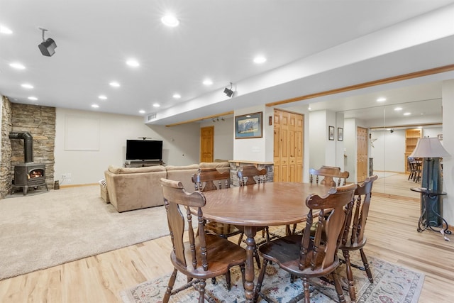1815 Homestead Dr, Missoula, MT 59808 - dining space featuring a wood stove, light wood-type flooring, and recessed lighting