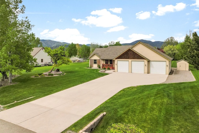 1815 Homestead Dr, Missoula, MT 59808 - ranch-style house with a storage unit, a front lawn, concrete driveway, an attached garage, and an outbuilding