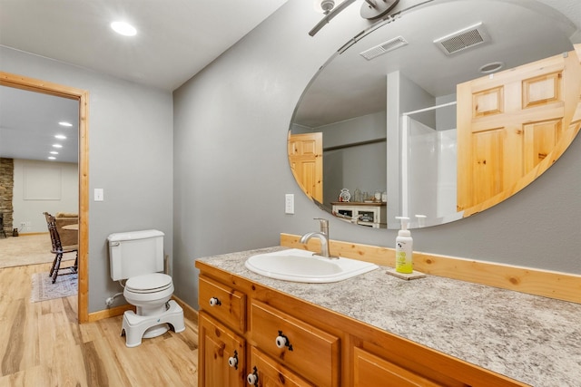 1815 Homestead Dr, Missoula, MT 59808 - bathroom with wood finished floors, toilet, vanity, baseboards, and a shower