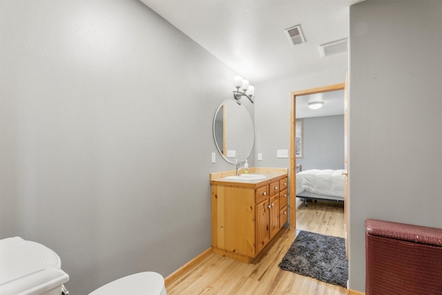 1815 Homestead Dr, Missoula, MT 59808 - ensuite bathroom featuring toilet, wood finished floors, vanity, and baseboards