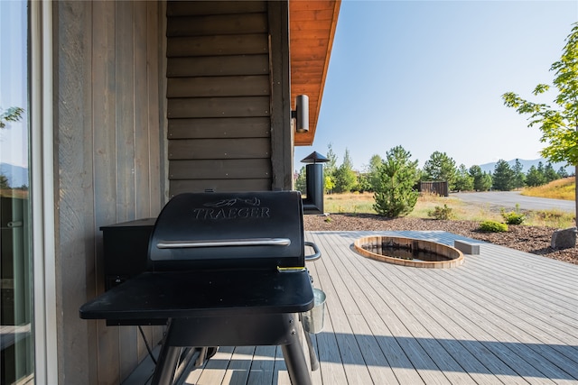 34 Park Cottage Way, Eureka, MT 59917 - wooden terrace with an outdoor fire pit and a grill