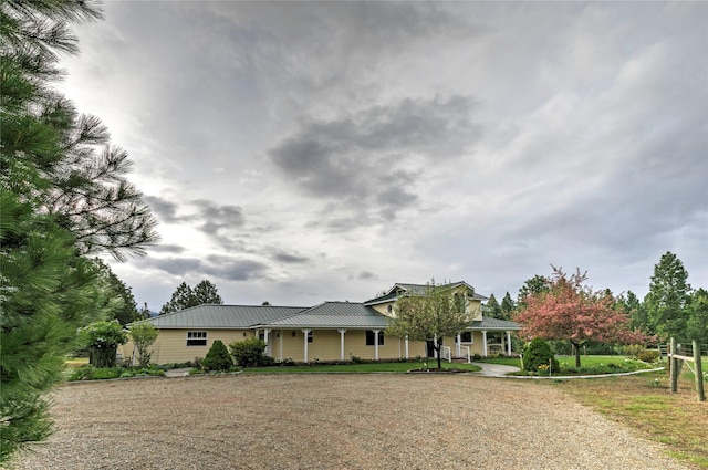 view of front of property featuring metal roof and covered porch