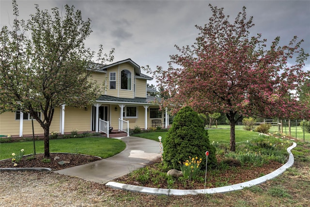 view of front of house featuring a porch, a standing seam roof, and metal roof
