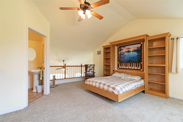 bedroom with carpet, lofted ceiling, baseboards, and a sink