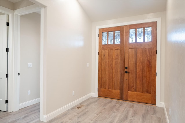 412 White Fox Run, Polson, MT 59860 - foyer entrance featuring light wood-style floors and baseboards
