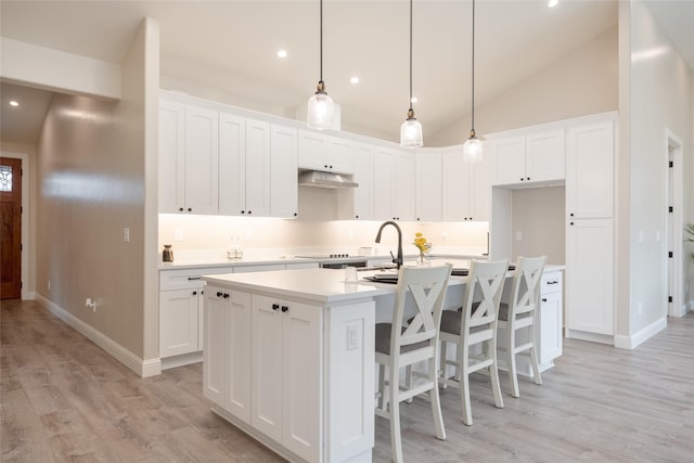 412 White Fox Run, Polson, MT 59860 - kitchen with a center island with sink, light wood finished floors, white cabinets, light countertops, and recessed lighting