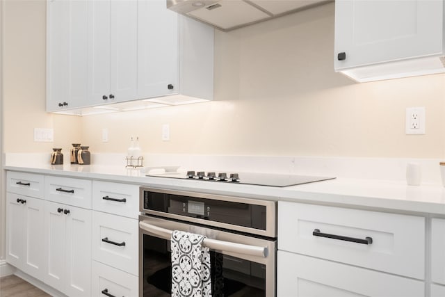 412 White Fox Run, Polson, MT 59860 - kitchen featuring stainless steel oven, light countertops, and white cabinets