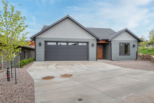 412 White Fox Run, Polson, MT 59860 - view of front of property featuring driveway, board and batten siding, an attached garage, and cooling unit