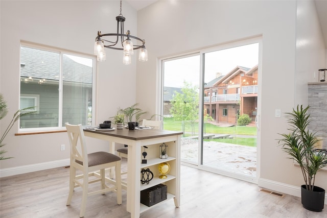 412 White Fox Run, Polson, MT 59860 - dining area featuring healthy amount of natural light, light wood finished floors, and a chandelier