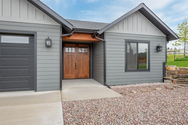412 White Fox Run, Polson, MT 59860 - doorway to property featuring board and batten siding and a garage