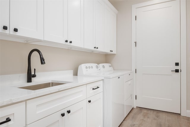 412 White Fox Run, Polson, MT 59860 - clothes washing area featuring cabinet space, washer and dryer, and light wood finished floors