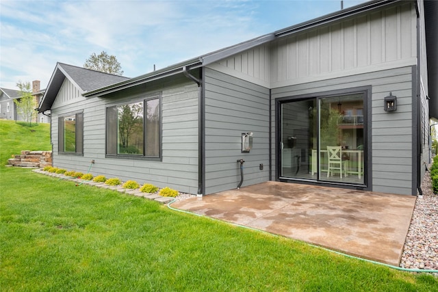 412 White Fox Run, Polson, MT 59860 - rear view of house featuring a patio area, a yard, and board and batten siding