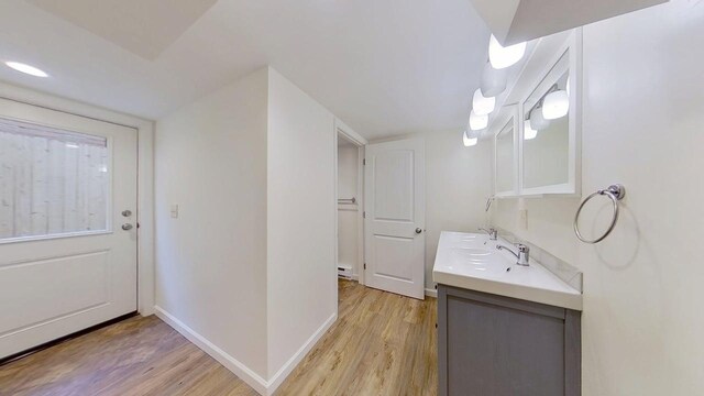 1240 Cannon St, Helena, MT 59601 - bathroom featuring wood finished floors, vanity, baseboards, and a baseboard radiator