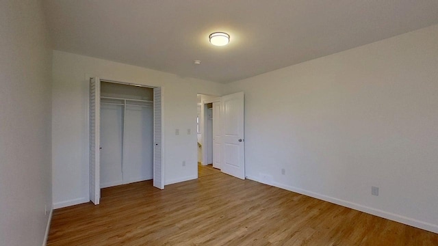 1240 Cannon St, Helena, MT 59601 - unfurnished bedroom with light wood finished floors, baseboards, and a closet