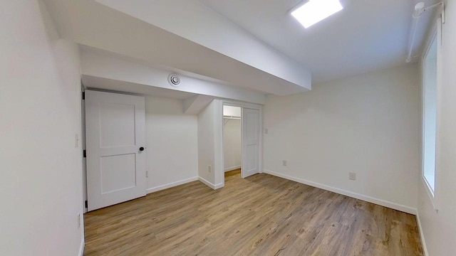 1240 Cannon St, Helena, MT 59601 - finished basement with light wood-style flooring and baseboards