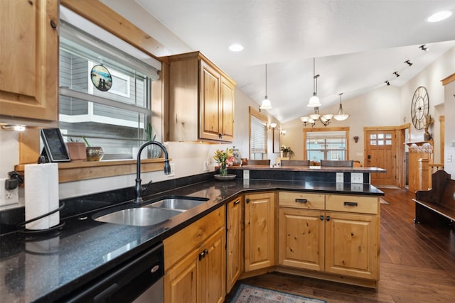 2442 Riata Rd, Missoula, MT 59808 - kitchen featuring a sink, a peninsula, dark wood finished floors, a chandelier, and vaulted ceiling
